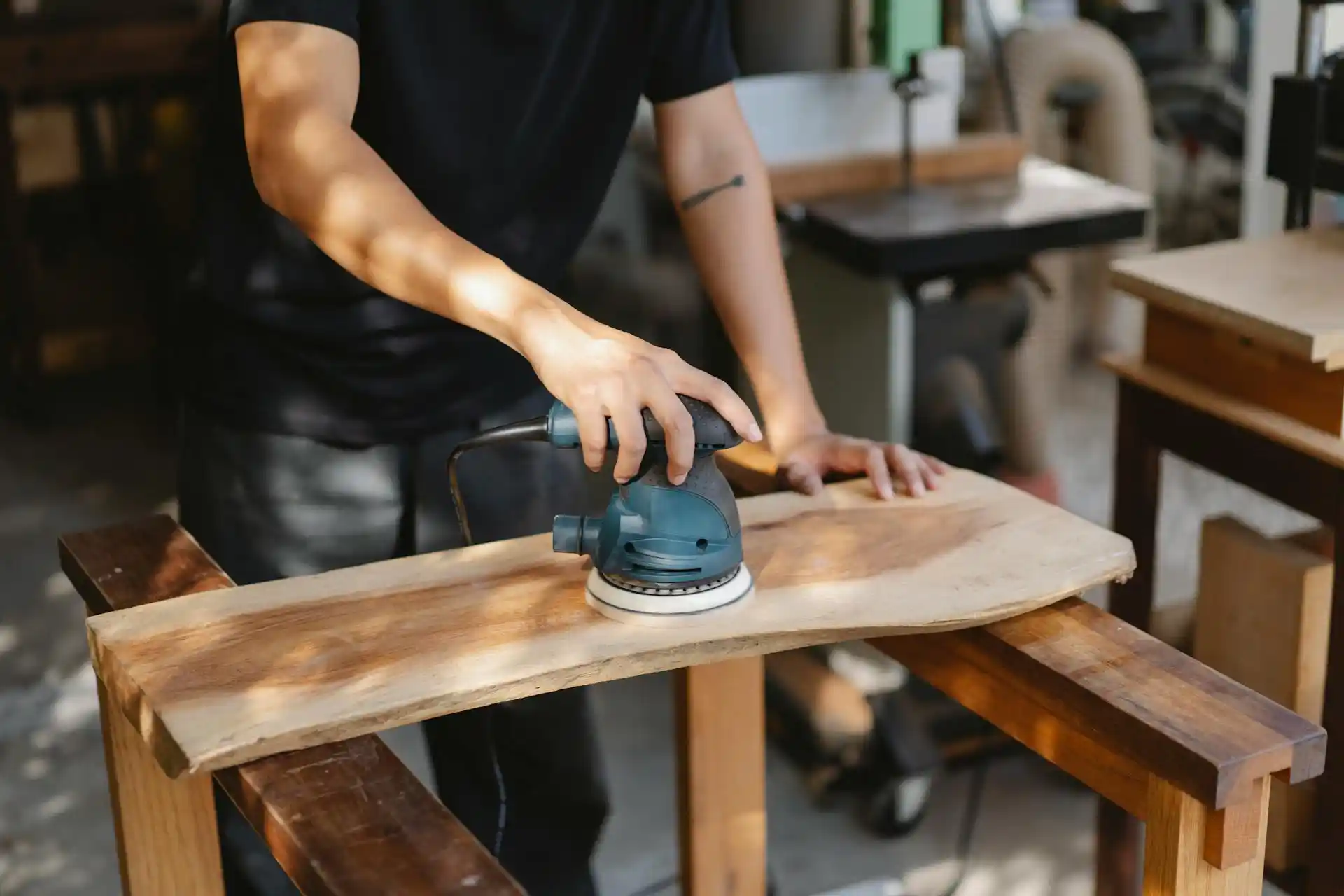A man trimming lumber in a workshop